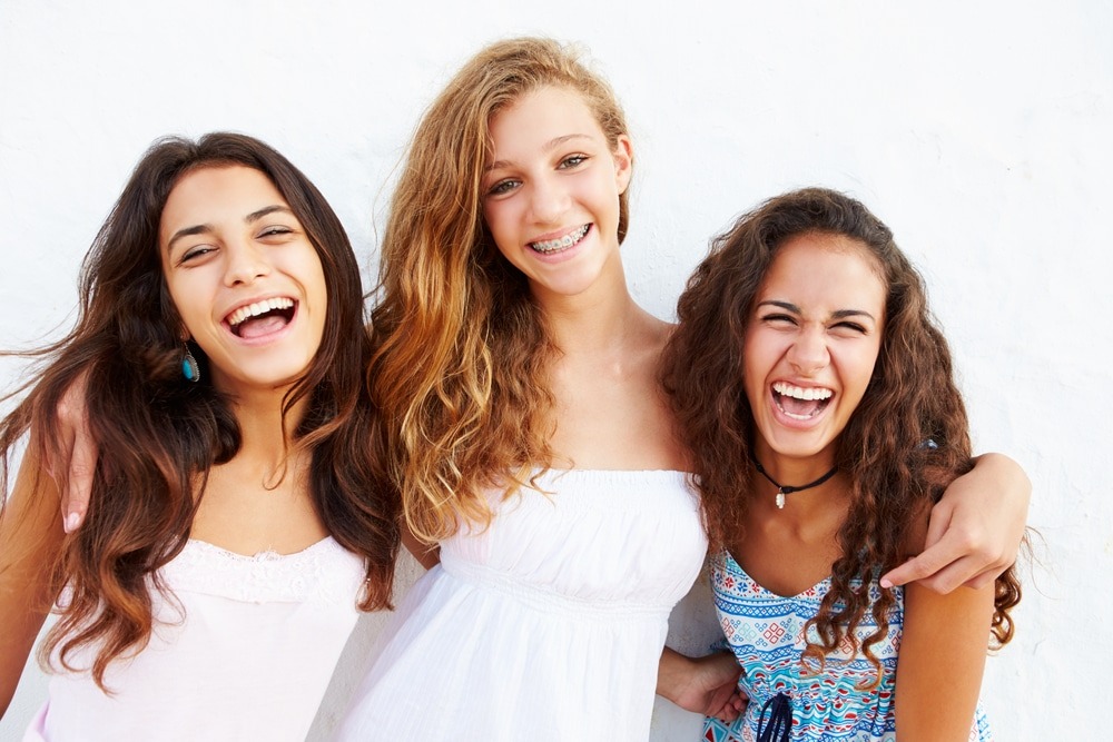 Portrait,Of,Three,Teenage,Girls,Leaning,Against,Wall