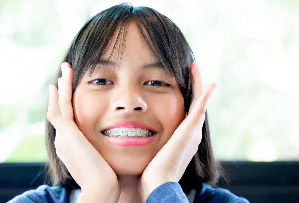 Girl with dental braces smiling and happy Teen girl smiling comfortably a few days after getting braces