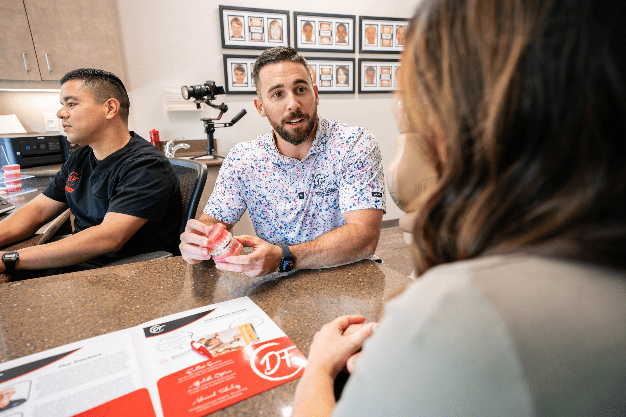 Orthodontist reviewing metal braces treatment options during a patient consultation